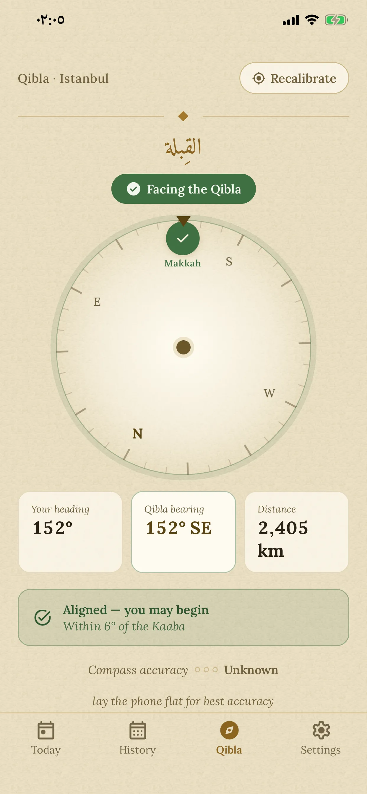 The Qibla compass aligned: the dial and Makkah badge turned green, with the message “Aligned — you may begin”.